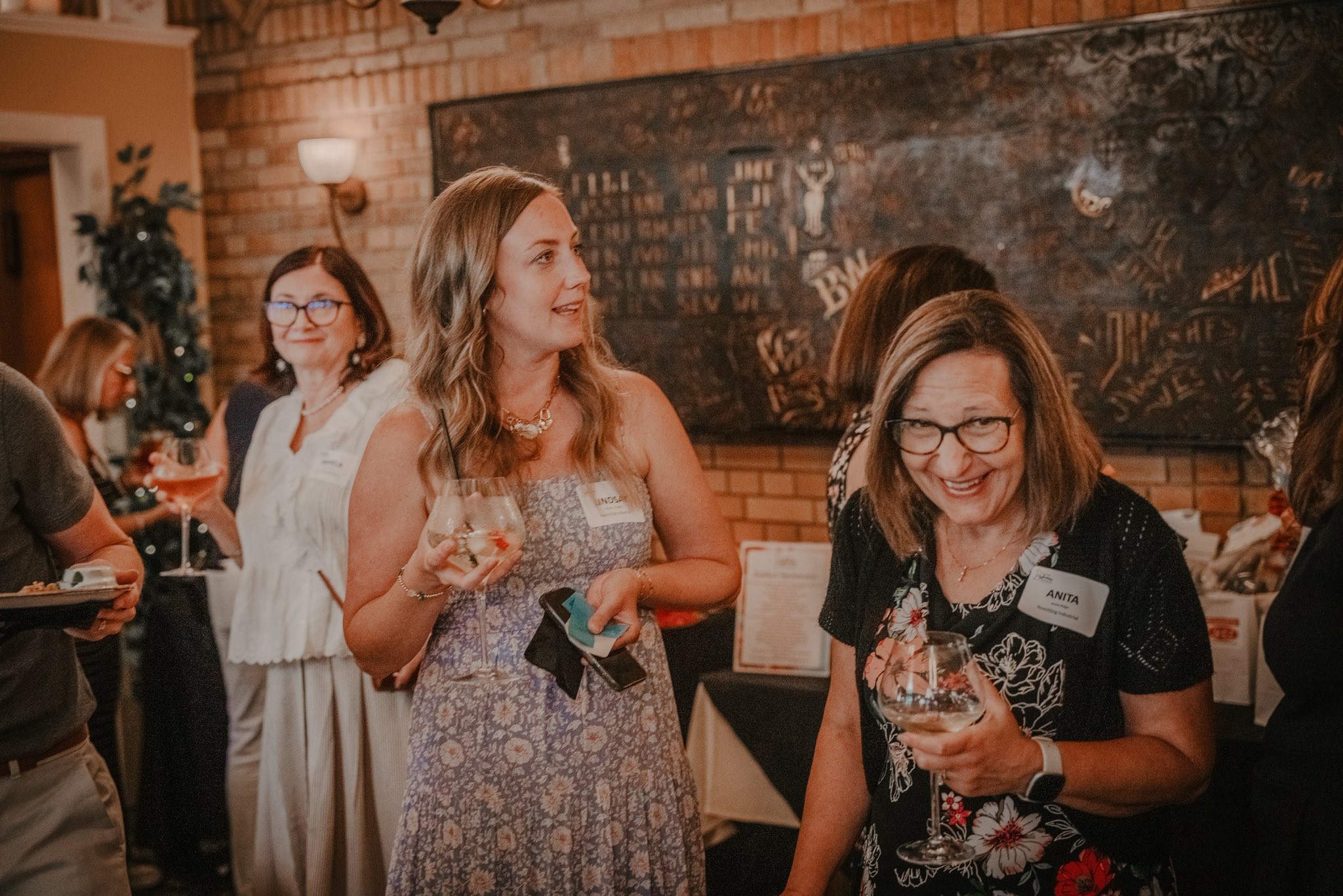 a group of several women talking at the Women of Westmoreland networking event