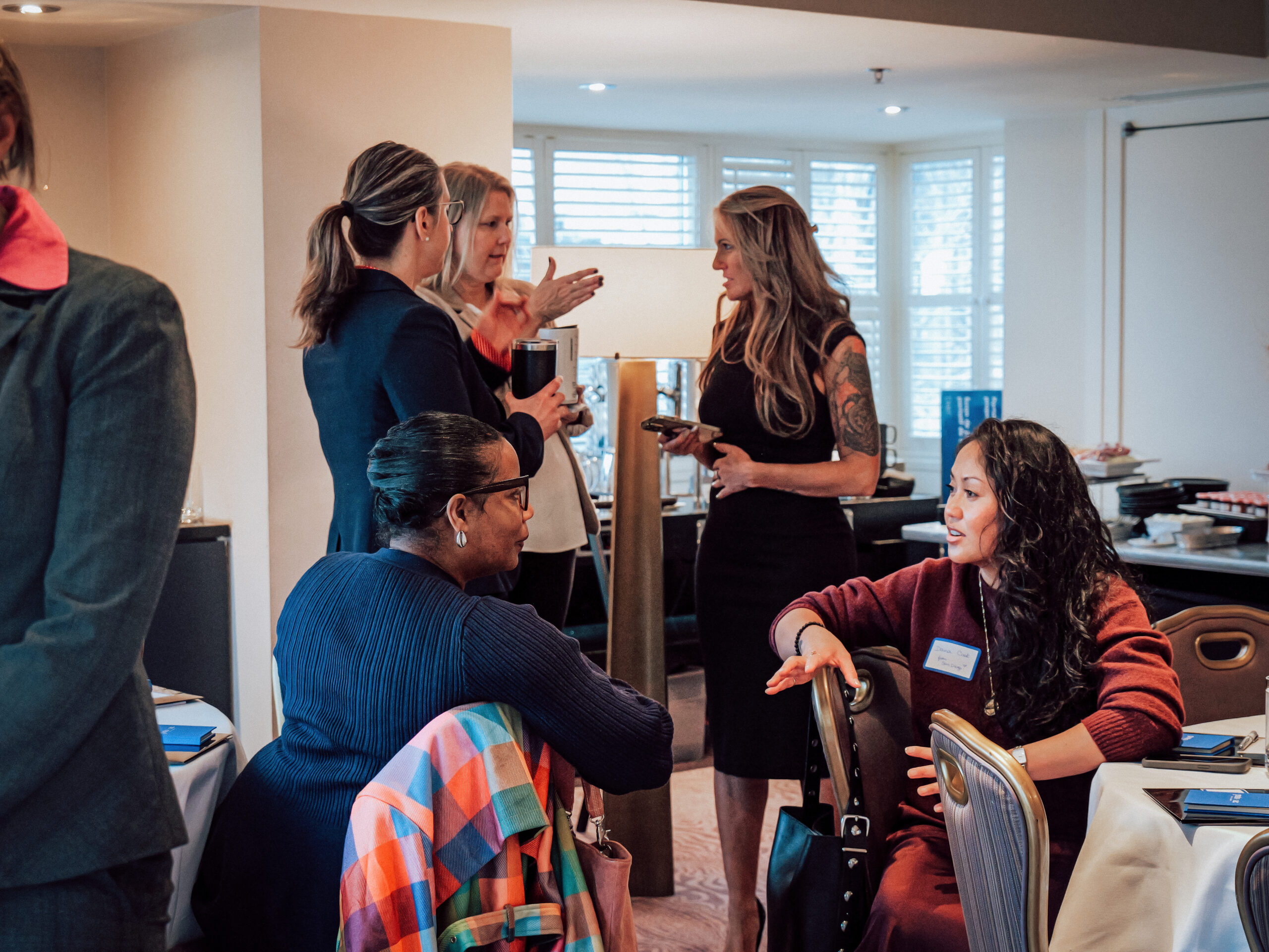 female attendees engaging in conversation at the AWE Women’s Business Summit