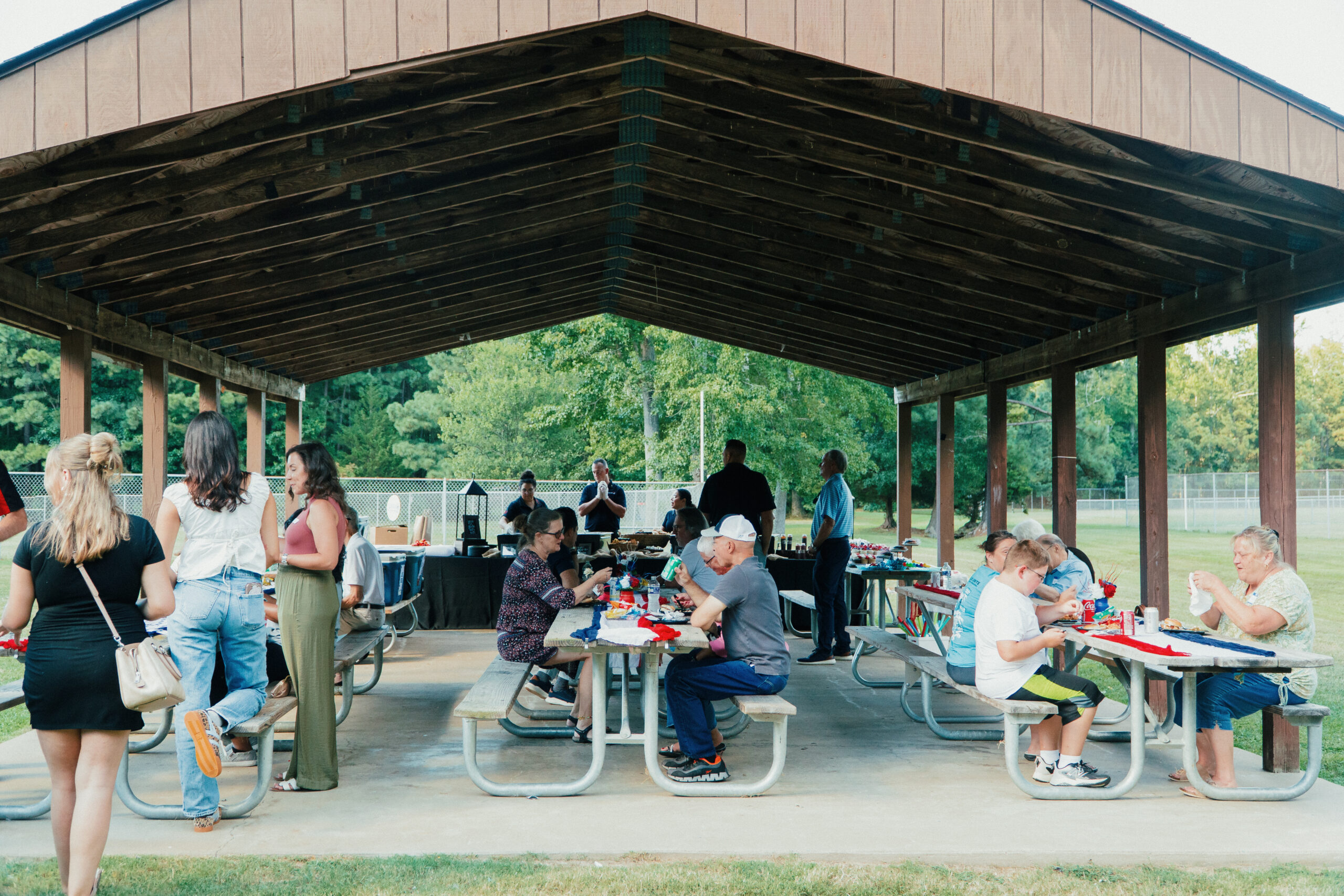 clients and families sitting in the outdoor pavilion at the First Annual YTS Virginia Branch Family Picnic
