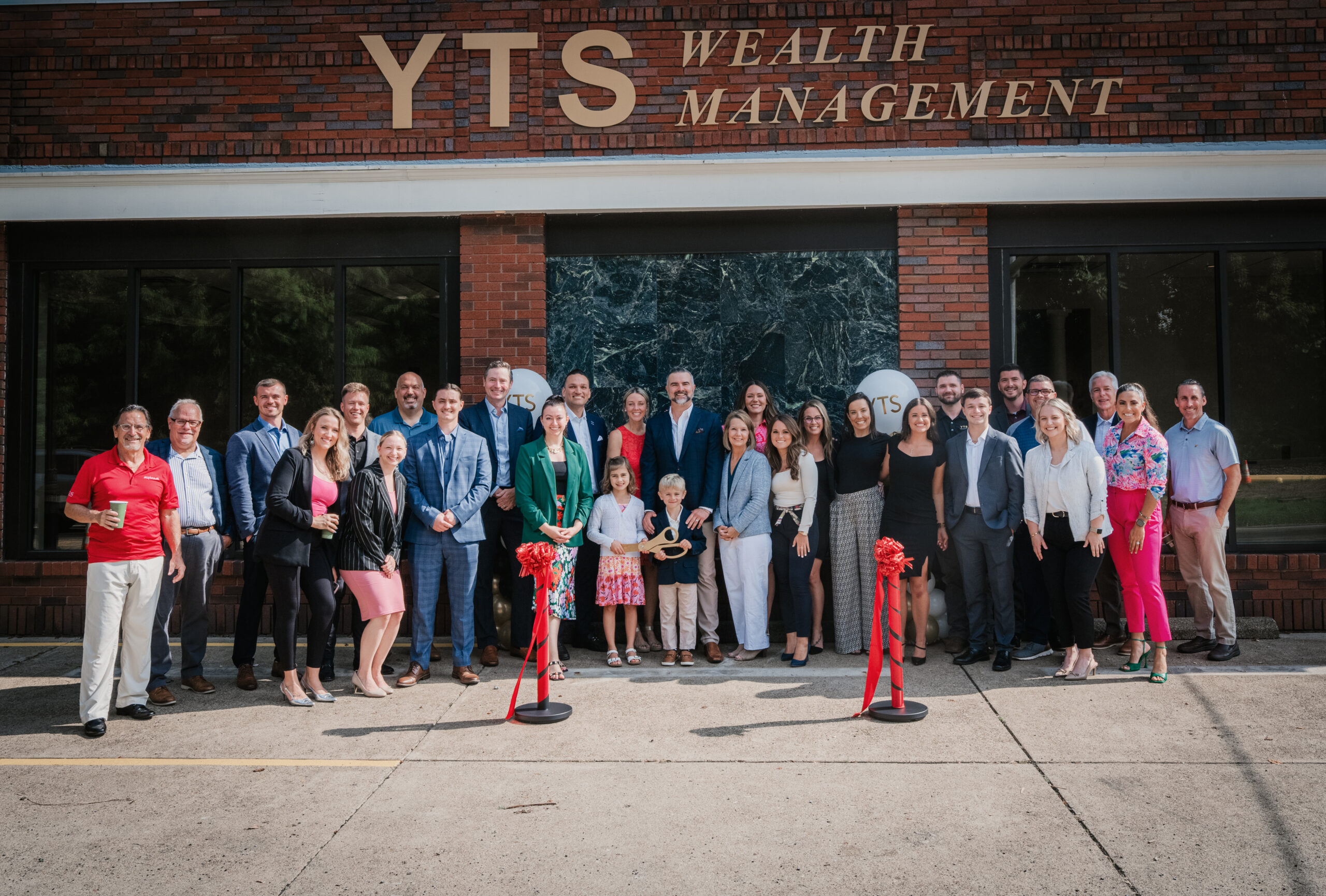 YTS Wealth Management team in front of the building during the Aspinwall Branch Ribbon Cutting